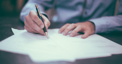 Doctor writing on papers